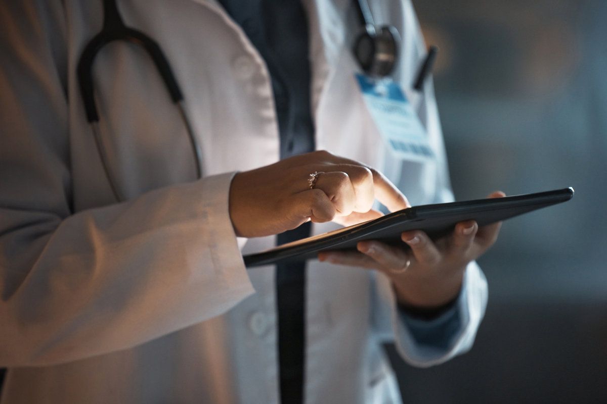 Pathologist reviewing digital pathology case results on a tablet