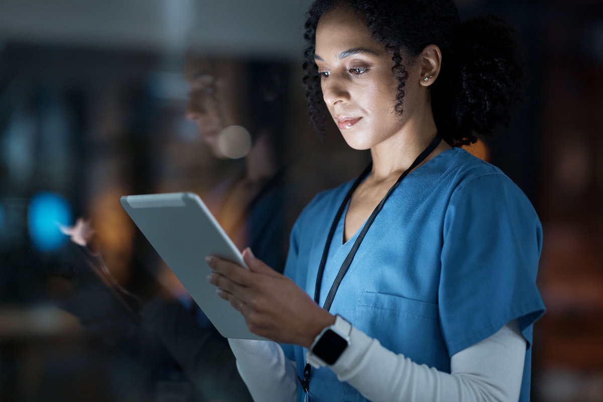 Laboratory professional using digital pathology software on a tablet